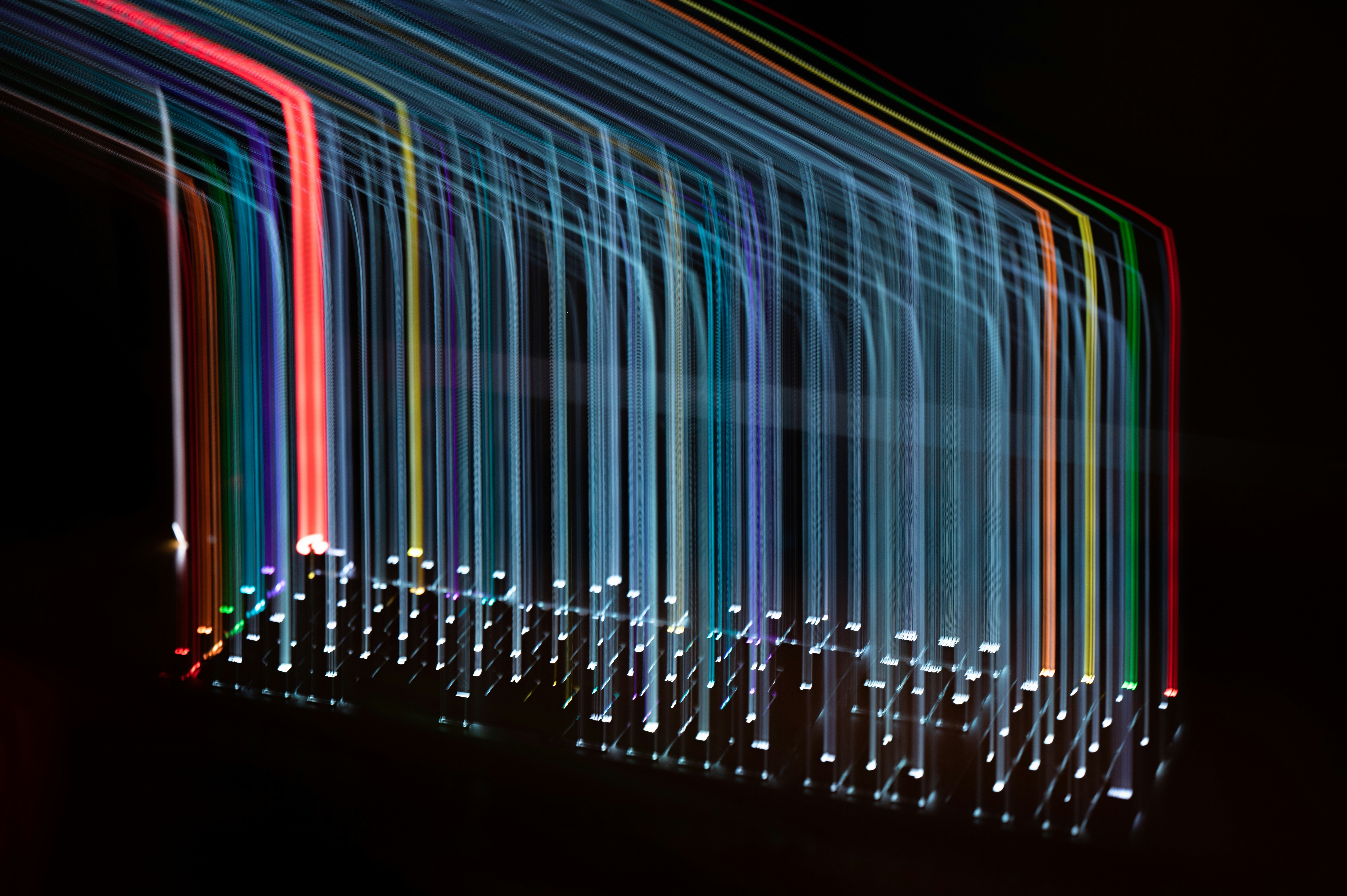 Abstract long-exposure light trails evoking data flow through infrastructure